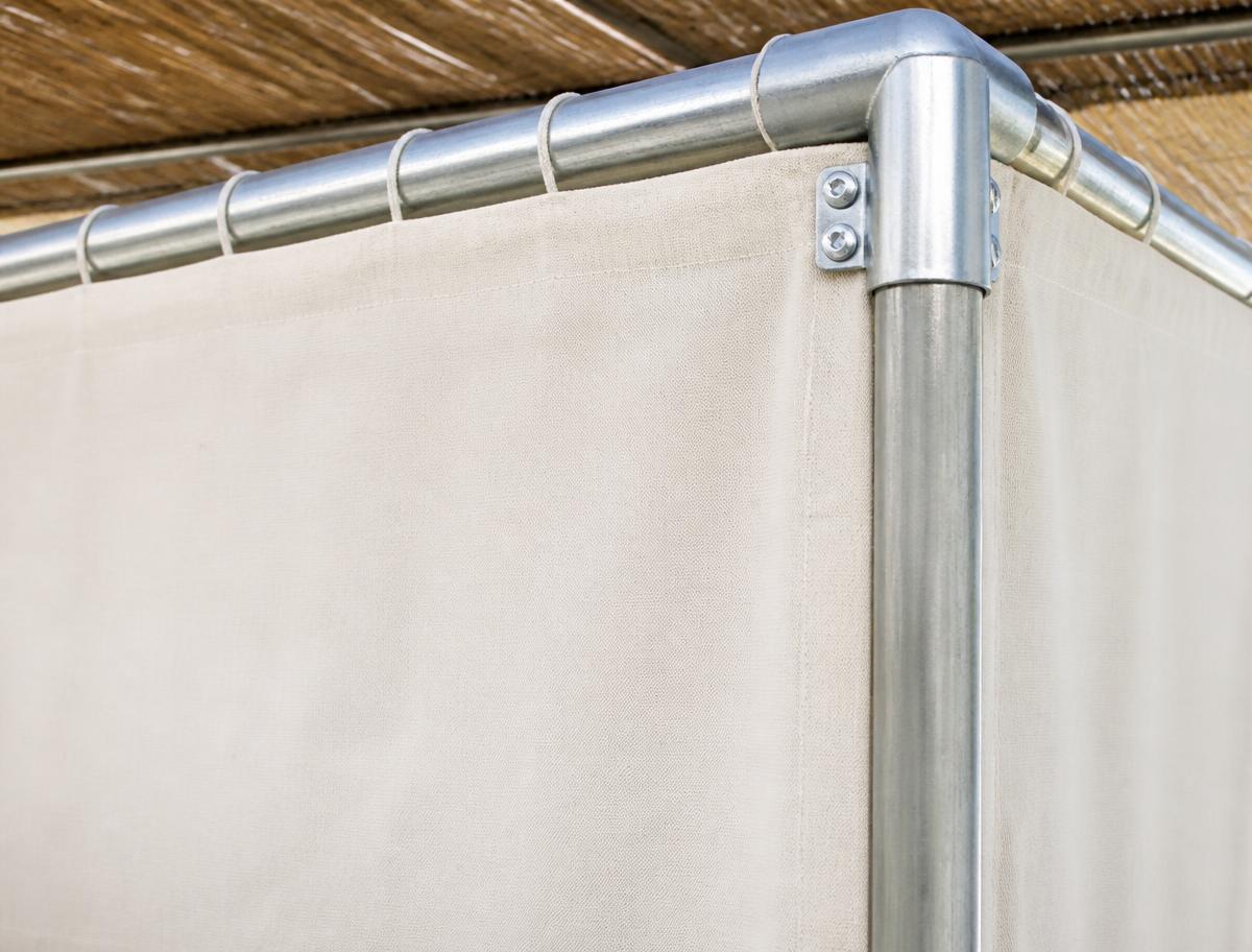 Close-up of a clean canvas sukkah wall and its metal frame corner connector