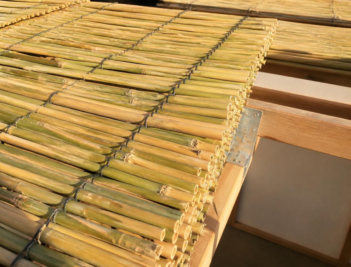 Angled close-up of fresh bamboo schach mats on a sukkah roof